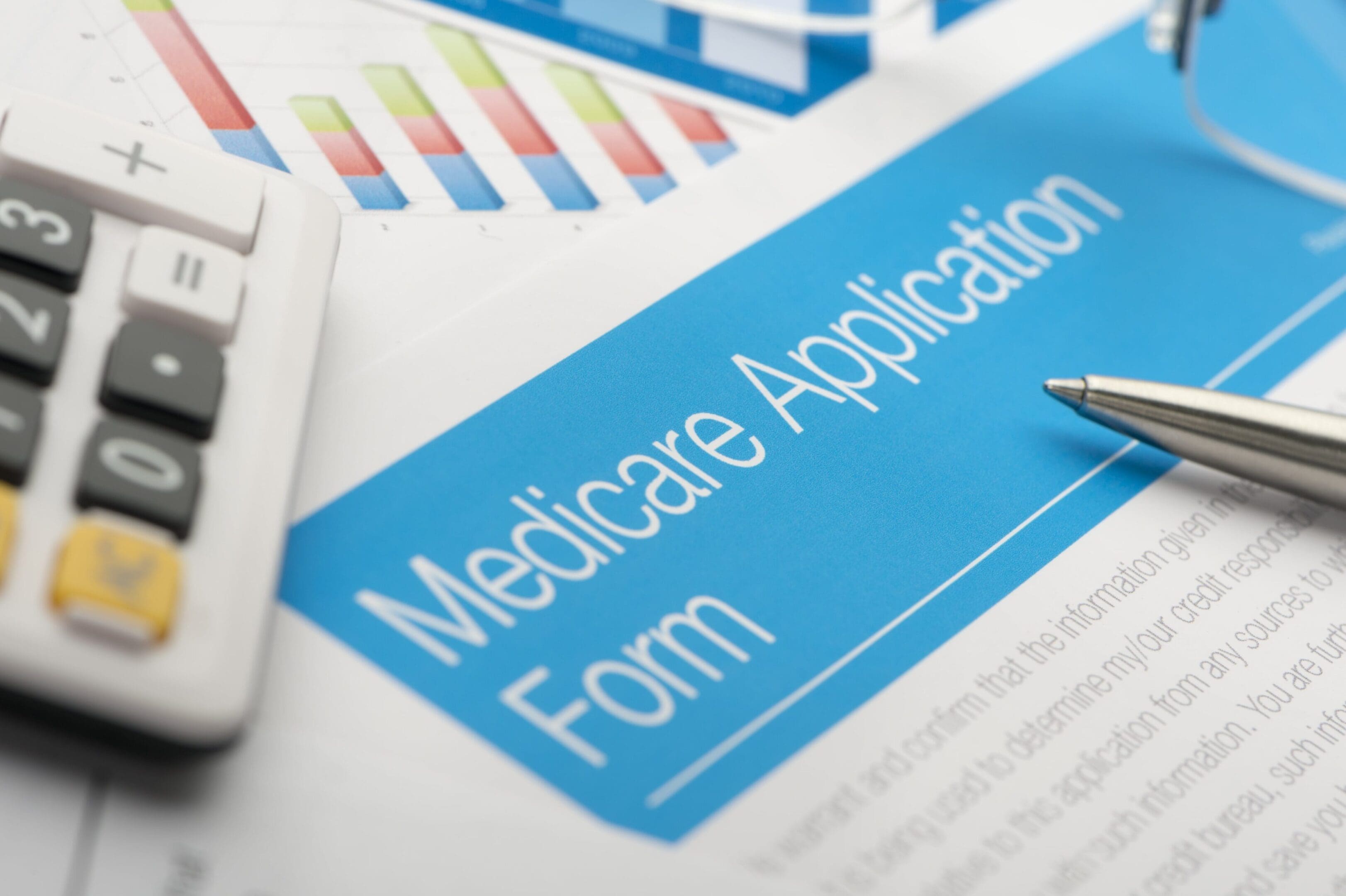 A medicare application form is shown on top of the table.